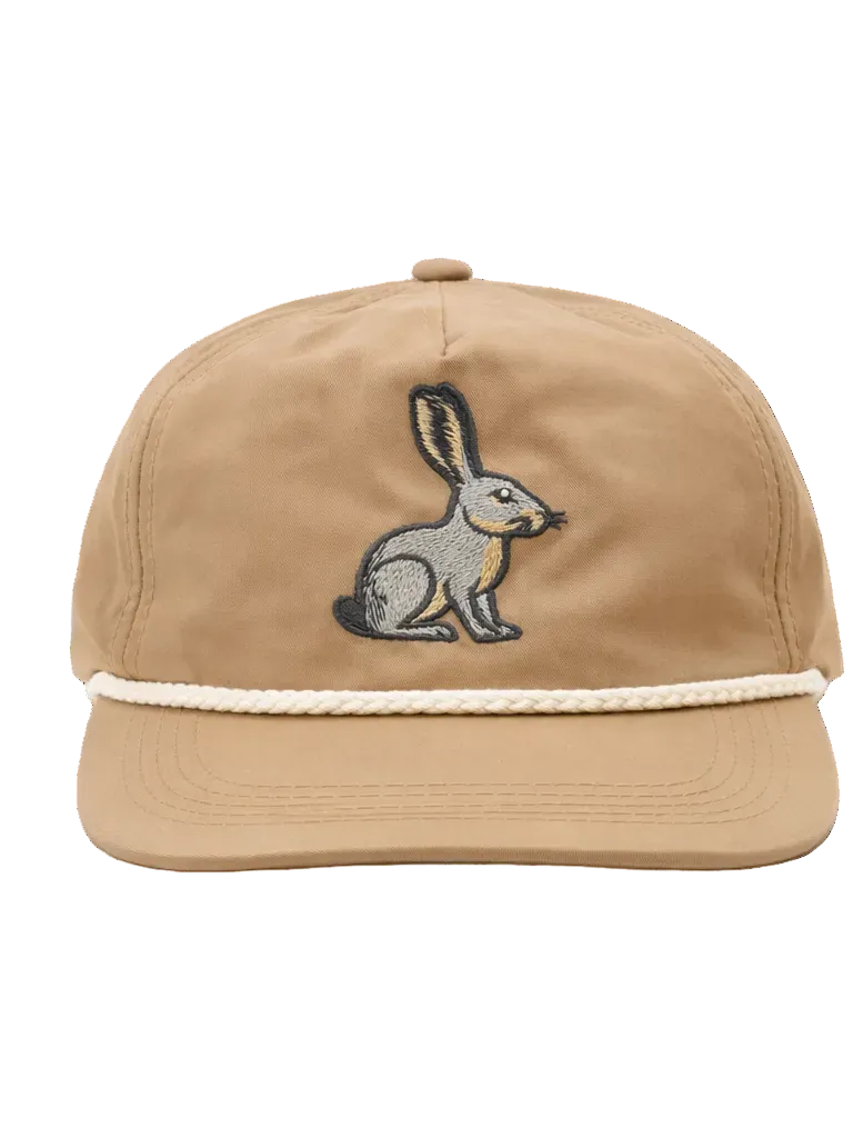 Beige cap with embroidered rabbit design on a white background