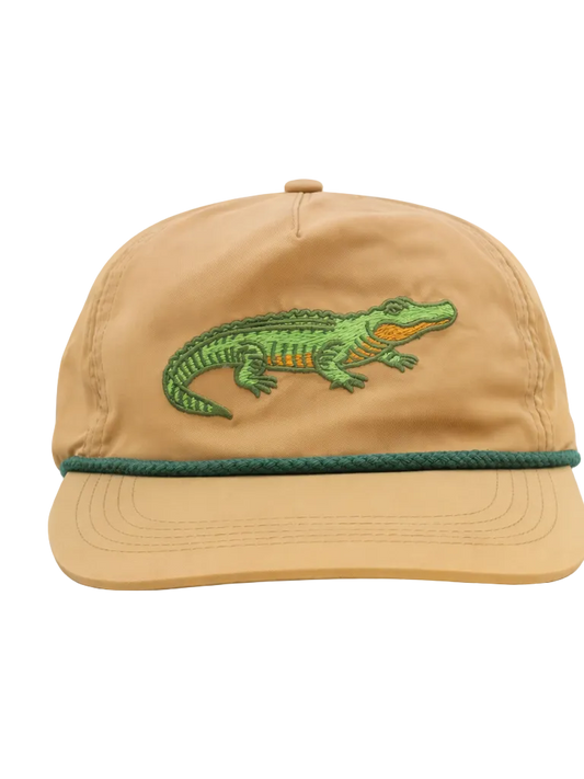 Tan cap with green alligator embroidery on a white background