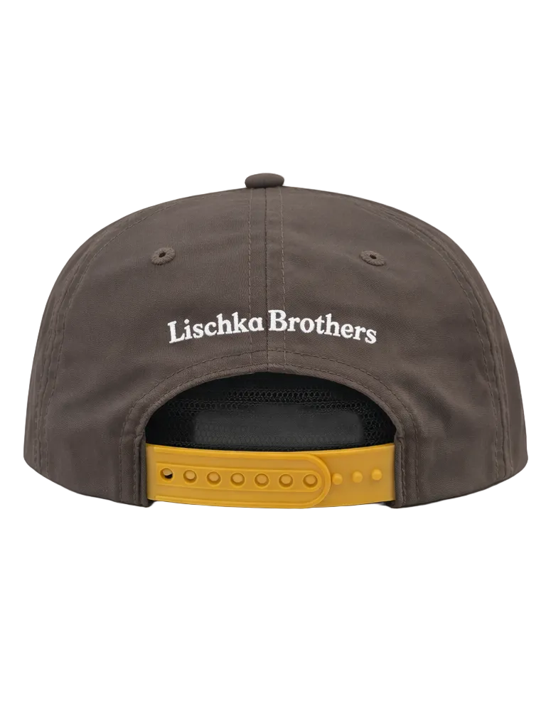 Brown cap with 'Lischka Brothers' logo on a white background